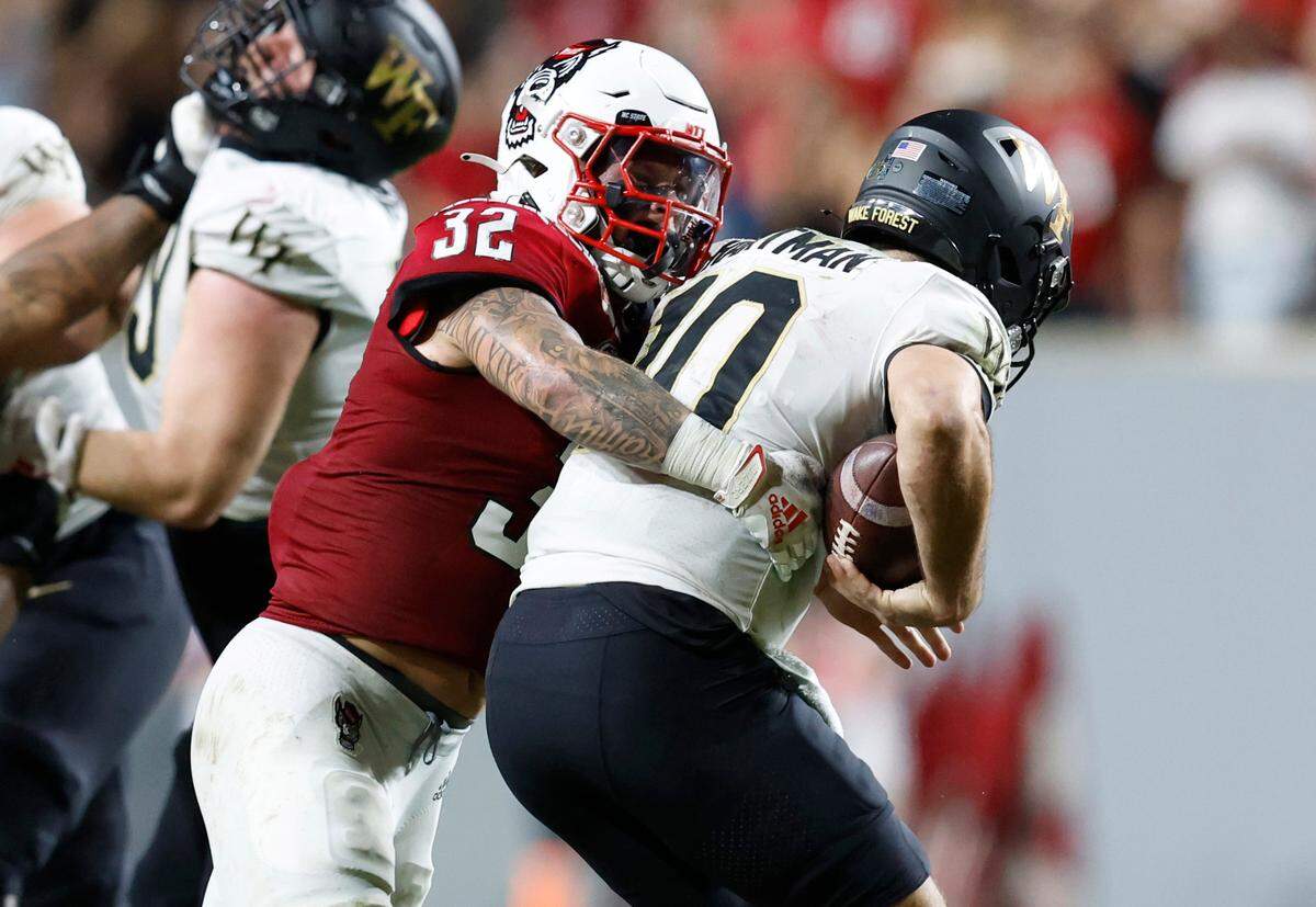 N.C. State linebacker Drake Thomas (32) sacks Wake Forest quarterback Sam Hartman (10) during the second half of N.C. State’s 30-21 victory over Wake Forest at Carter-Finley Stadium in Raleigh, N.C., Saturday, Nov. 5, 2022.