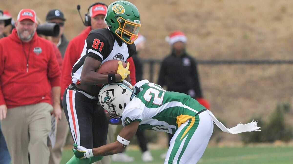 South Carolina receiver Yannick Smith of Summerville High, East Carolina commit, catches a pass near North Carolina defensive back Landan Callahan of Reagan High, committed to Duke University during the fourth quarter of the Shrine Bowl of the Carolinas football game at Viking Stadium in Spartanburg, S.C. Saturday, December 16, 2023.