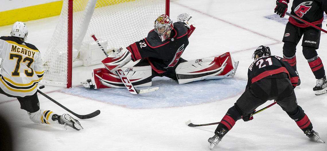 Carolina Hurricanes goalie Antii Raanta (32) rejects a shot attempt by Boston Bruins Charlie McAvoy (73) in the second period on Monday, May 2, 2022 during game one of their Stanley Cup first round series at PNC Arena in Raleigh, N.C.
