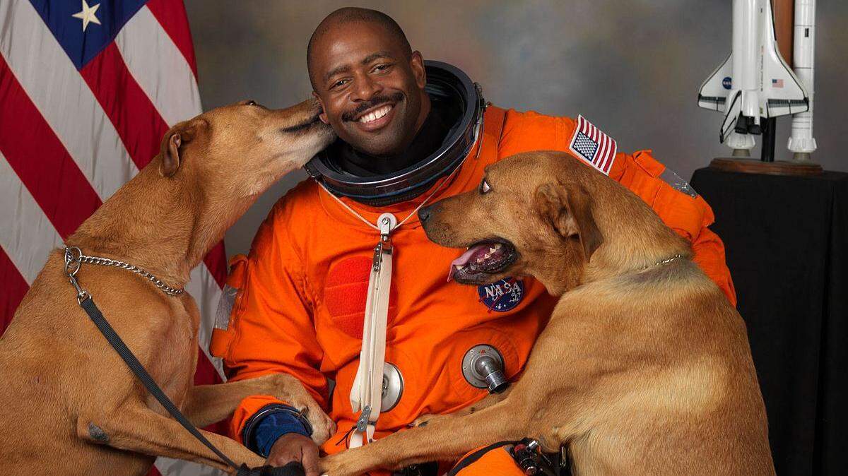 Former NASA astronaut Leland Melvin with his dogs Jake and Scout. Melvin, also briefly an NFL wide receiver, will speak Wednesday at Quail Ridge Books about his book, "Chasing Space."