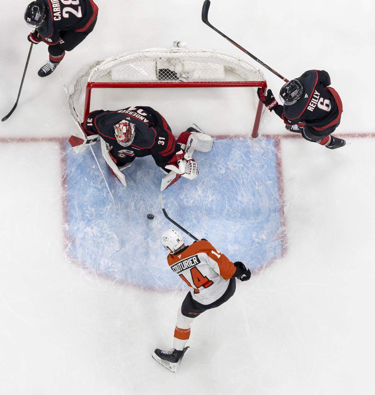 Philadelphia center Sean Couturier (14) scores on Carolina Hurricanes goalie Frederik Andersen (31) to take a 2-0 led in the first period in Game 2 on Monday, May 4, 2026, during the second round of the Stanley Cup Playoffs at Lenovo Center in Raleigh, N.C.