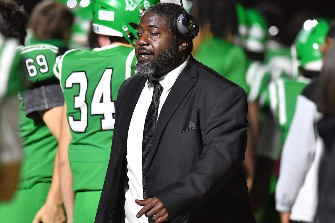 Cary football head coach Coleman Tyrance watches the setup on the field against Middle Creek during the first half. The Cary Imps and the Middle Creek Mustangs met in a conference football game in Cary, N.C. on October 24, 2025