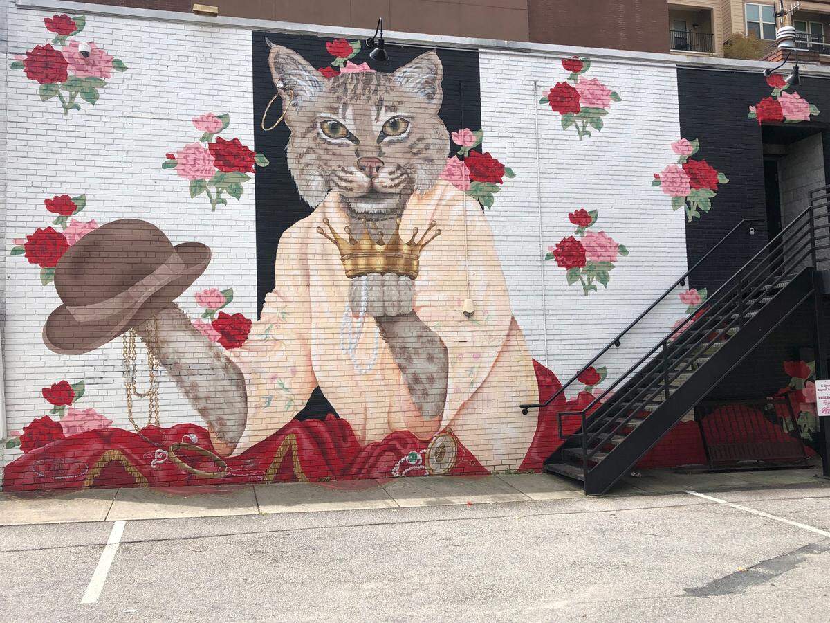 Sprinkles the Cat was painted by Lisa Gaither in 2015 on the side of C Grace at 407 Glenwood Ave.