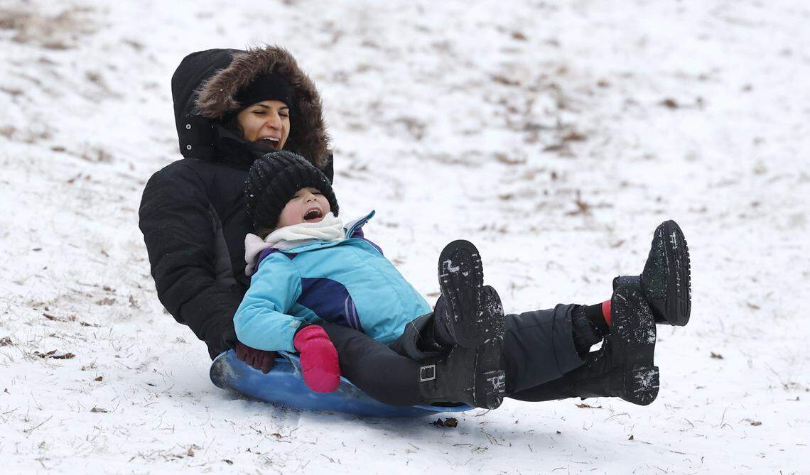 Sara Prado and her daughter Luna, 7, sled down a hill at Dix Park in Raleigh Sunday morning, Jan. 25, 2026.