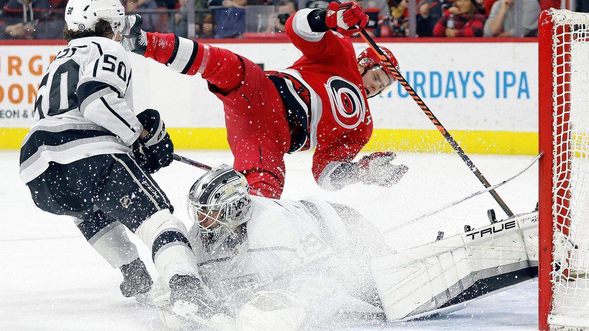 Carolina Hurricanes’ Sebastian Aho (20) trips over Los Angeles Kings goaltender Pheonix Copley (29) with Sean Durzi (50) nearby during the third period of an NHL hockey game in Raleigh, N.C., Tuesday, Jan. 31, 2023. (AP Photo/Karl B DeBlaker)