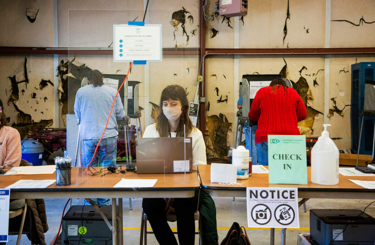 Douglas Toth, left, and Joy Renfro, right, husband and wife, cast their ballots together on Election Day at the Bahama Fire Station 2, on Nov. 3, 2020, in Bahama, N.C.