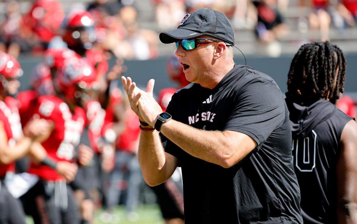 N.C. State head coach Dave Doeren encourages his team during warmups before during N.C. State’s game against Northern Illinois at Carter-Finley Stadium in Raleigh, N.C., Saturday, Sept. 28, 2024.