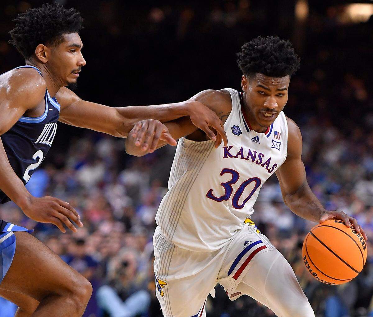 KU’s Ochai Agbaji drives around Villanova’s Jermaine Samuels during the second half of Saturday’s NCAA national semifinal at the Final Four at the Superdome in New Orleans. KU beat Villanova, 81-65.