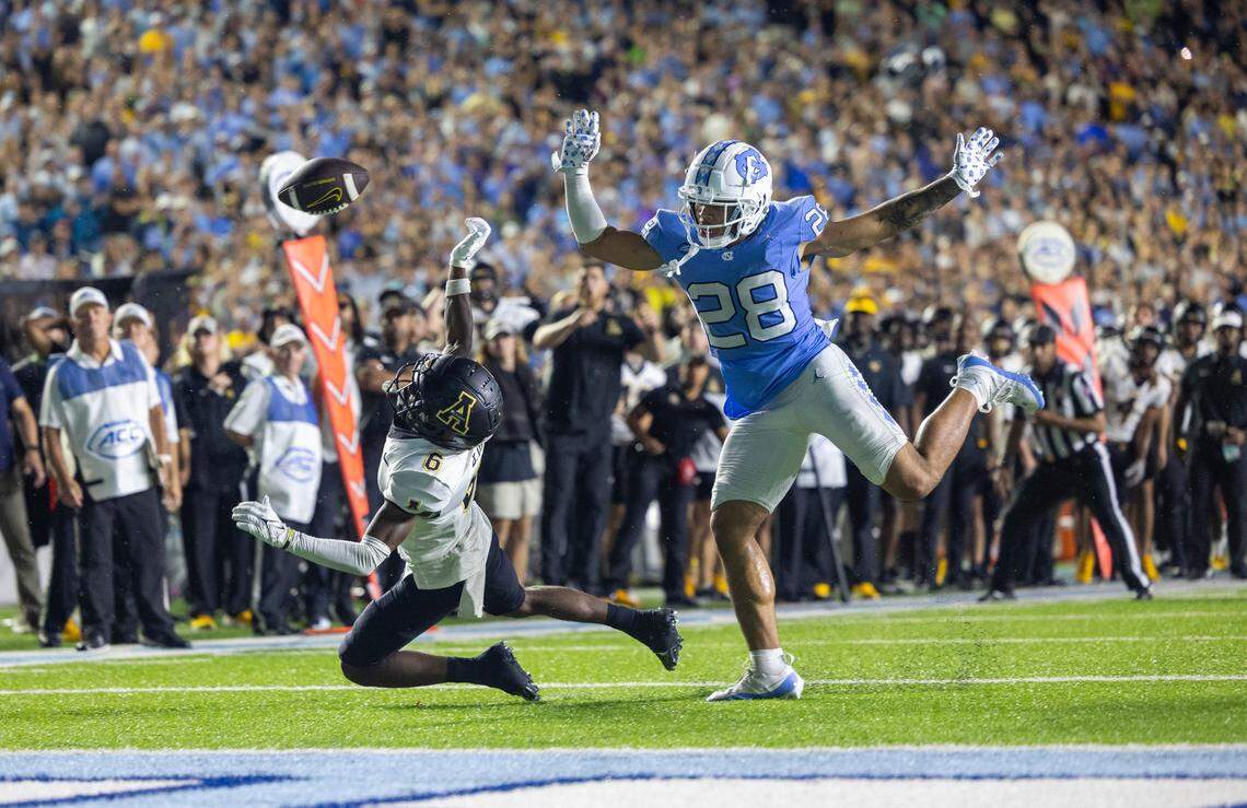 North Carolina’s Alijah Huzzie (28) defends Appalachian State’s Dashawn Davis (6) as he reaches for a pass from quarterback quarterback Joey Aguilar (4) on the final play in overtime on Saturday September 9, 2023 at Kenan Stadium in Chapel Hill, N.C. The pass was incomplete, securing the Tar Heels’ 40-34 overtime victory.