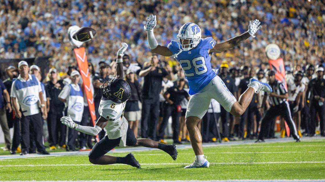 North Carolina’s Alijah Huzzie (28) defends Appalachian State’s Dashawn Davis (6) as he reaches for a pass from quarterback quarterback Joey Aguilar (4) on the final play in overtime on Saturday September 9, 2023 at Kenan Stadium in Chapel Hill, N.C. The pass was incomplete, securing the Tar Heels’ 40-34 overtime victory.