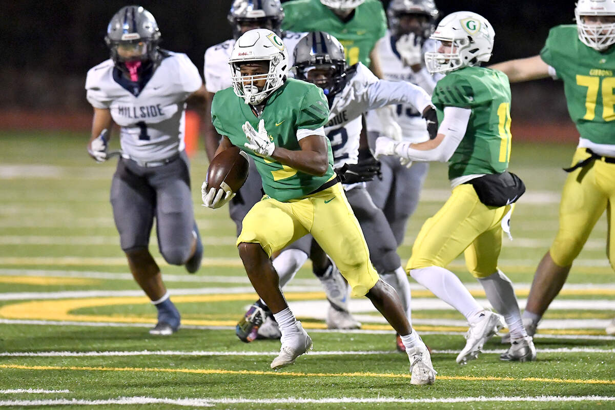 Cardinal Gibbons running back Kendall Scotton (5) runs for the long yards against Hillside during the first half. The Cardinal Gibbons Crusaders and the Durham Hillside Hornets met in the third round of the NCHSAA 4A playoffs in Raleigh, N.C. on November 29, 2024.