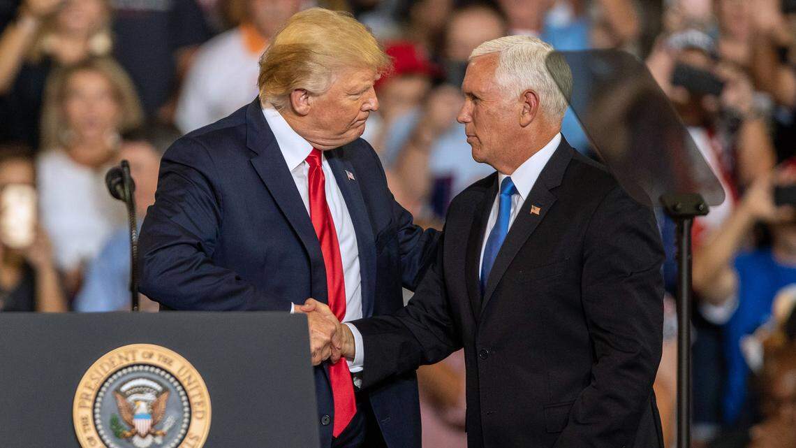 Vice President Mike Pence shakes hands with President Donald Trump after introducing him during a campaign rally Wednesday, July 17, 2019 at East Carolina University in Greenville, NC.