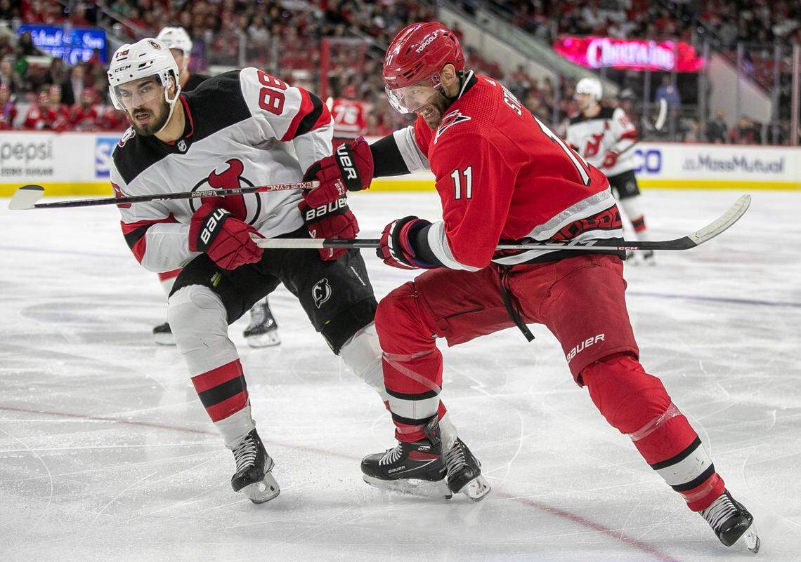 The Carolina Hurricanes Jordan Staal (11) battles for postion during a face-off with the New Jersey Devils Kevin Ball (88) in the first period of their second round Stanley Cup playoff series on Wednesday, May 3, 2023 at PNC Arena in Raleigh, N.C.
