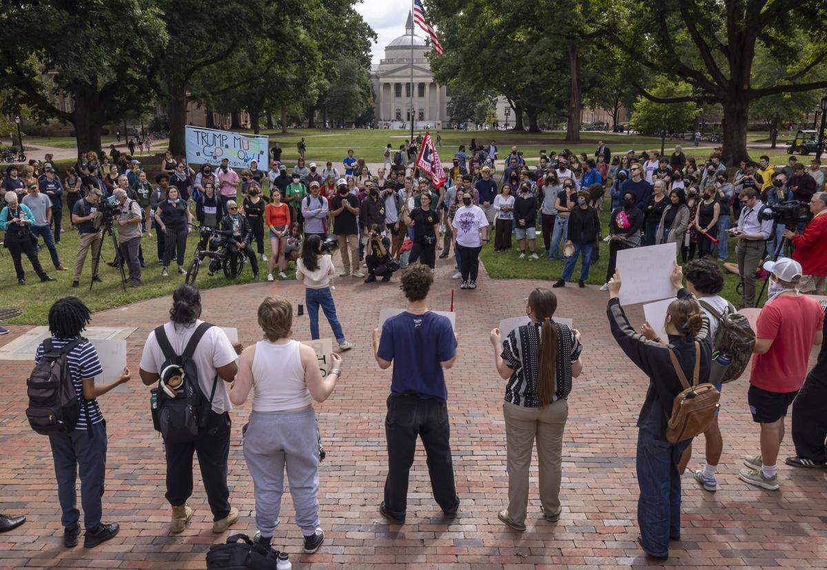 Demonstrators, made up of students, faculty and other free speech advocates, gather outside the South Building during a rally to show support for UNC associate professor Dwayne Dixon, who has been placed on administrative leave on Wednesday, October 1, 2025 in Chapel Hill, N.C.