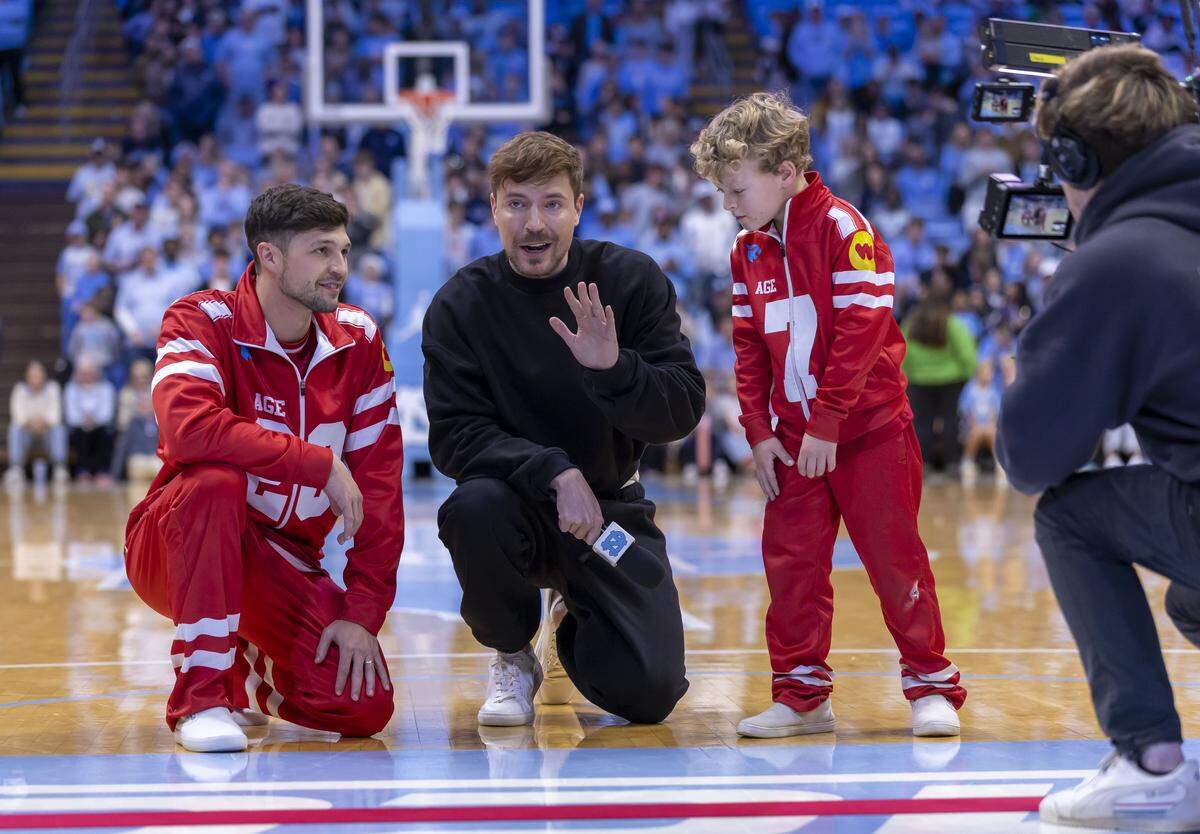 Jimmy Donaldson, the YouTube Influencer MrBeast, instructs contestants Tyler Gordon of Charlotte and seven-year-old Gunner Phillips of Cary, during a contest for $250,000 on Saturday , December 13, 2025 at the Smith Center in Chapel Hill, N.C.