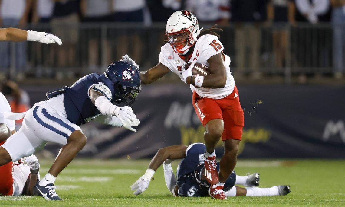 N.C. State wide receiver Keyon Lesane (15) gets around Connecticut defensive back Stan Cross (4) during the first half of N.C. State’s game against UConn at Rentschler Field in East Hartford, Conn. Thursday, August 31, 2023.