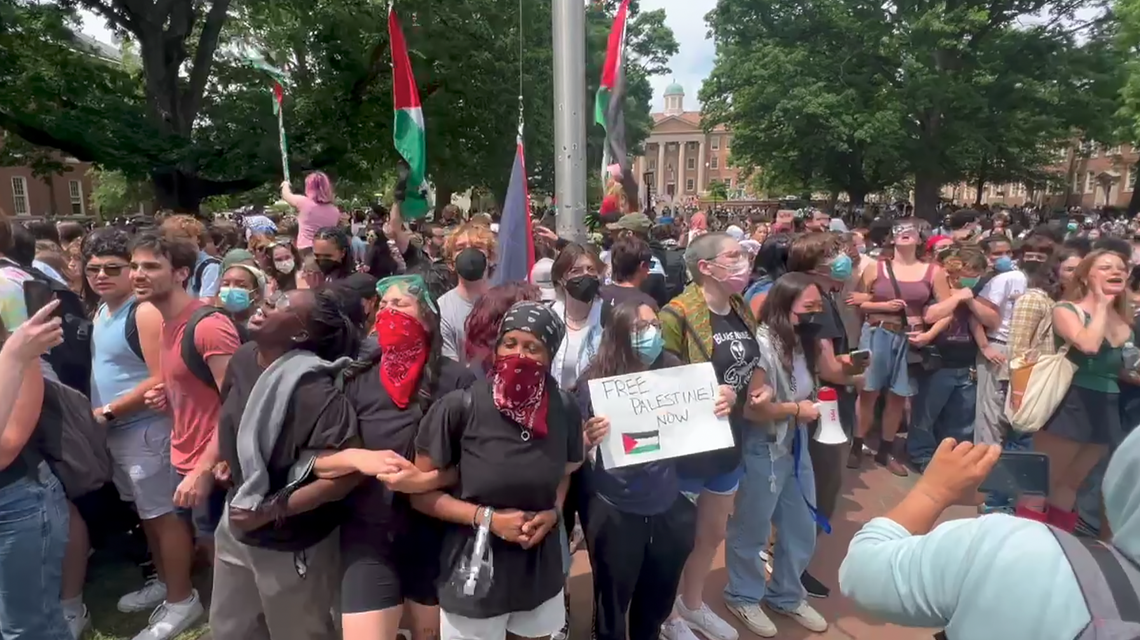 Demonstrators rally around a flag pole on the quad UNC’s campus in Chapel Hill, on Tuesday, April 30, 2024. The protest came after several people were detained by police at a pro-Palestinian “Gaza solidarity encampment” on the quad earlier that morning.
