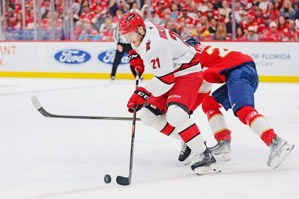 May 26, 2025; Sunrise, Florida, USA; Carolina Hurricanes defenseman Alexander Nikishin (21) moves the puck during the third period against the Florida Panthers in game four of the Eastern Conference Final of the 2025 Stanley Cup Playoffs at Amerant Bank Arena. 