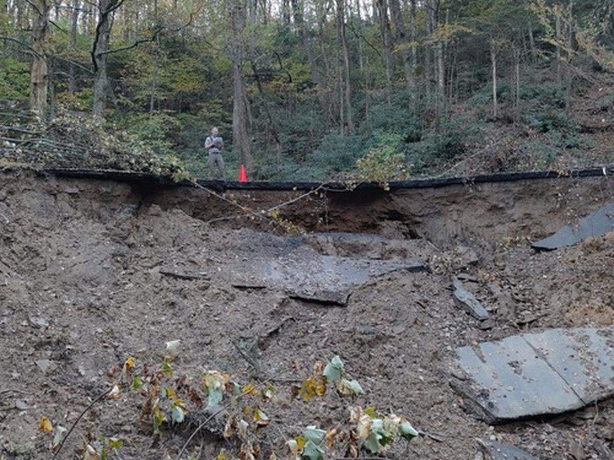 A National Park Service employee stands on a washed-out section of the Blue Ridge Parkway, at milepost 345 in North Carolina. Photo taken Oct. 6, 2024.