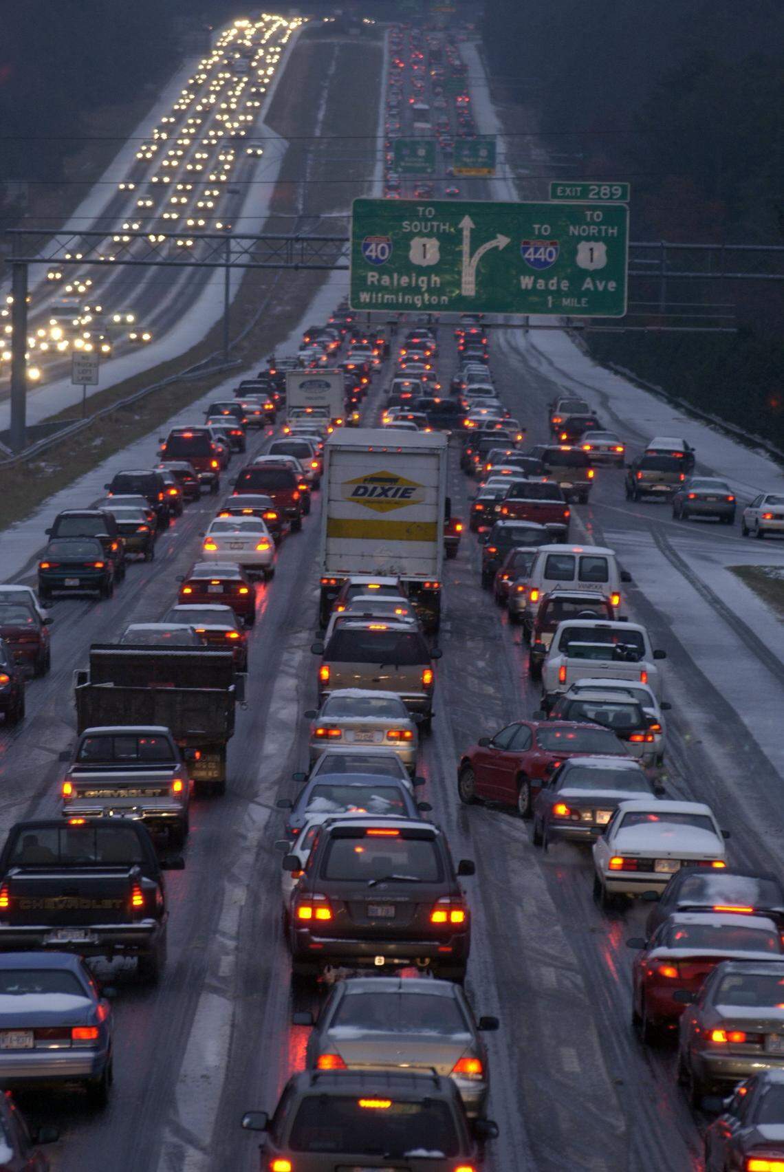 Afternoon traffic creeps in the eastbound lanes of I-40(right) toward Raleigh as seen from the Harrison Avenue overpass as icy conditions from a winter storm slowed the commute to a crawl.  A mixture of snow, sleet and freezing rain quickly stuck to roads Thursday afternoon, Dec. 4, 2002, and then begin to freeze into a sheet of ice, making travel difficult.  