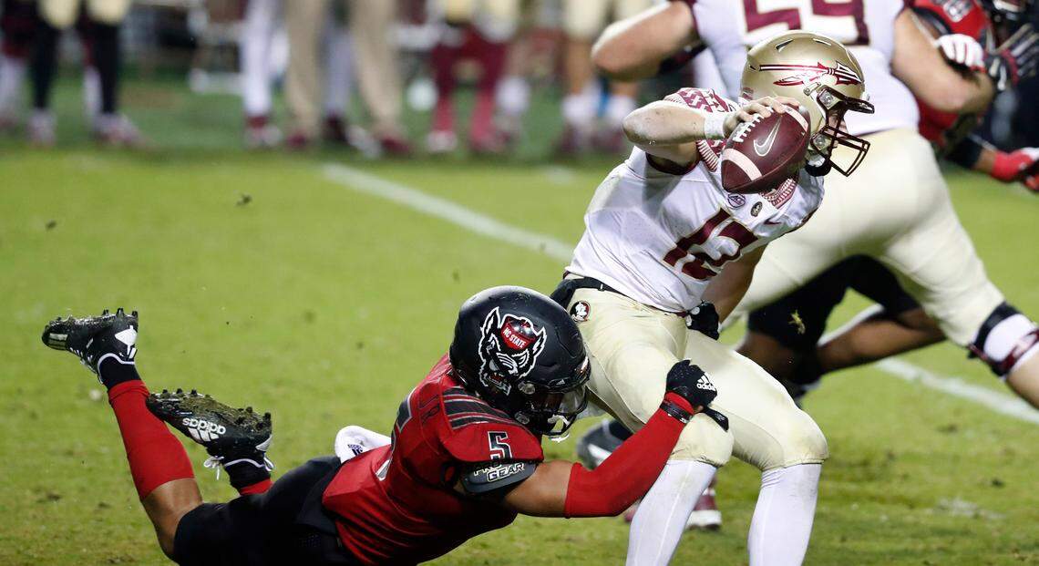 N.C. State linebacker C.J. Hart Jr. (5) sacks Florida State quarterback Chubba Purdy (12) during the second half of N.C. State’s 38-22 victory over Florida State at Carter-Finley Stadium in Raleigh, N.C., Saturday, Nov. 14, 2020.