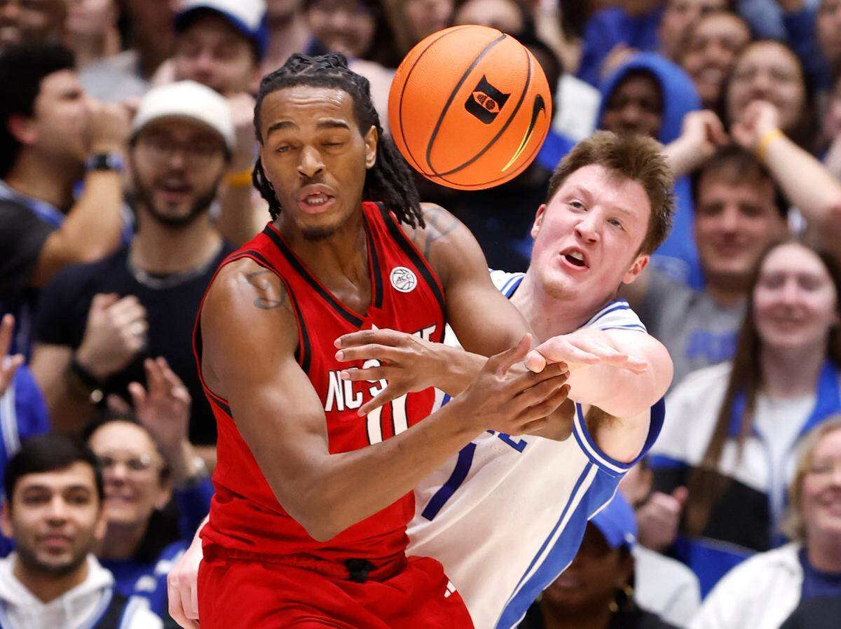 Duke’s Kon Knueppel (7) knocks the ball from N.C. State’s Dennis Parker Jr. (11) during the first half of Duke’s game against N.C. State at Cameron Indoor Stadium in Durham, N.C., Monday, Jan. 27, 2025.