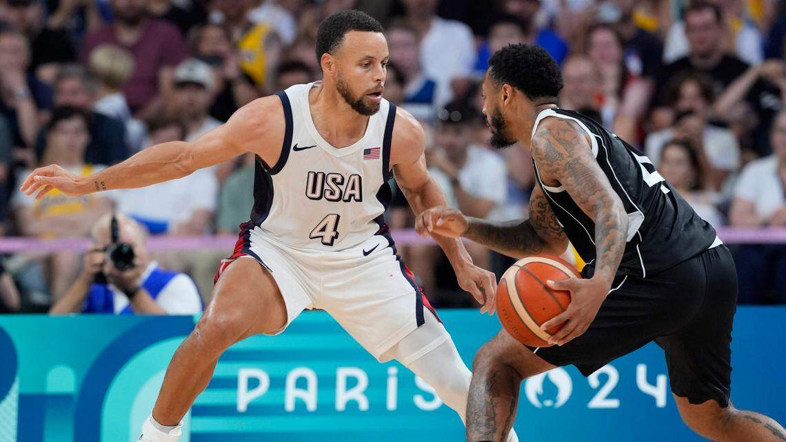 Jul 31, 2024; Villeneuve-d’Ascq, France; United States shooting guard Stephen Curry (4) defends South Sudan guard Carlik Jones (4) in the fourth quarter during the Paris 2024 Olympic Summer Games at Stade Pierre-Mauroy.