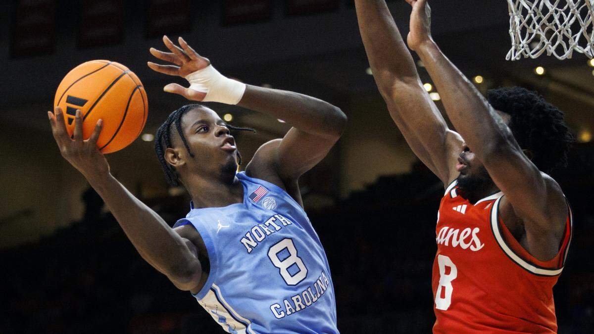 North Carolina Tar Heels forward Caleb Wilson (8) shoots the ball over Miami Hurricanes center Ernest Udeh Jr. (8) during the second half of a game on Tuesday, Feb. 10, 2026.