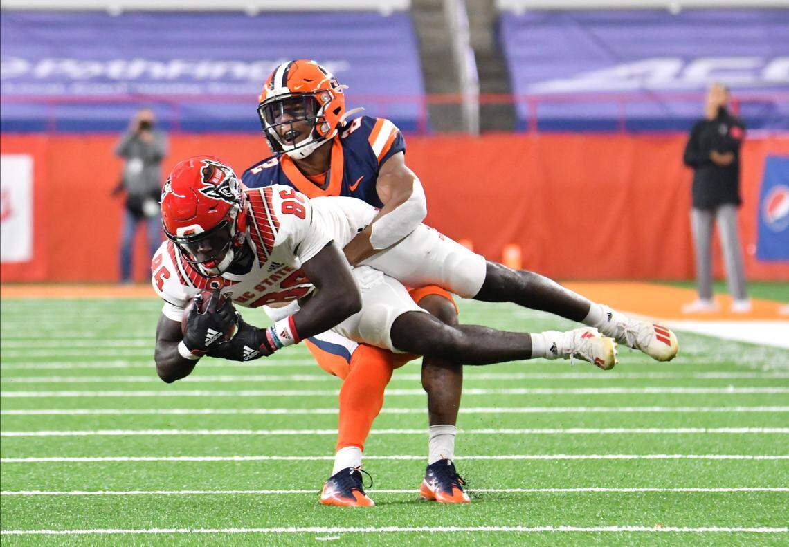 North Carolina State Wolfpack wide receiver Emeka Emezie (86) is tackled by Syracuse Orange defensive back Kyle Strickland (22) in the first quarter at the Carrier Dome.