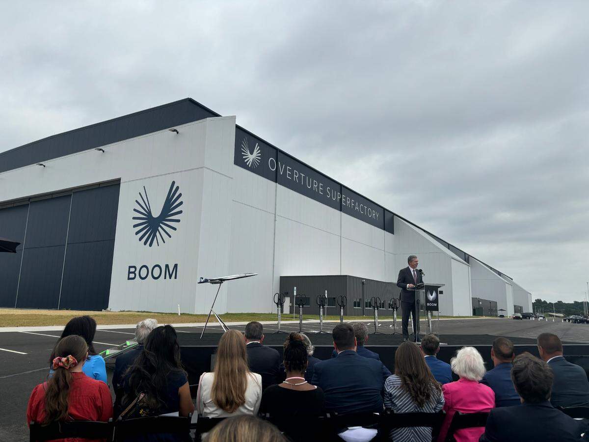 North Carolina Gov. Roy Cooper speaks in front of Boom Supersonic’s first manufacturing site at the Piedmont Triad International Airport on June 17, 2024.