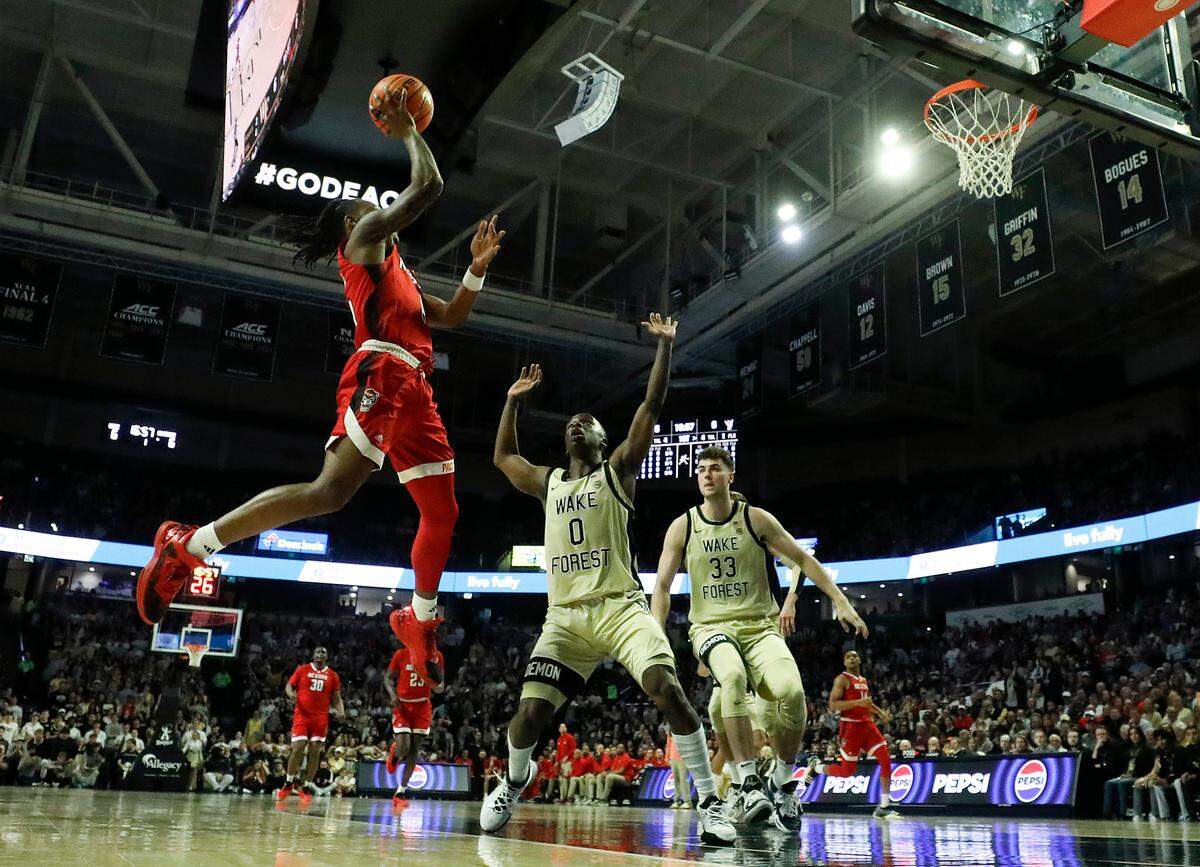 N.C. State’s DJ Horne drives to the basket against Wake Forest’s Kevin Miller during the first half of the Wolfpack’s 83-79 loss on Saturday, Feb. 10, 2024, at Lawrence Joel Veterans Memorial Coliseum in Winston-Salem, N.C.