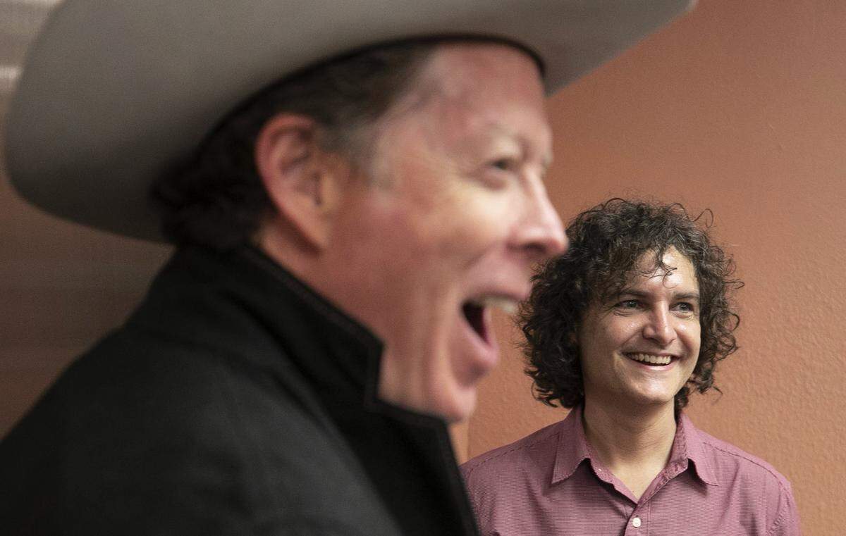 Hot Rize’s Nick Forster laughs as he waits for the elevator in the green room at Meymandi Concert Hall with William Lewis the executive director of Pinecone on Thursday, November 15, 2018 in Raleigh, N.C. Lewis was helping the band load out their equipment following their show.