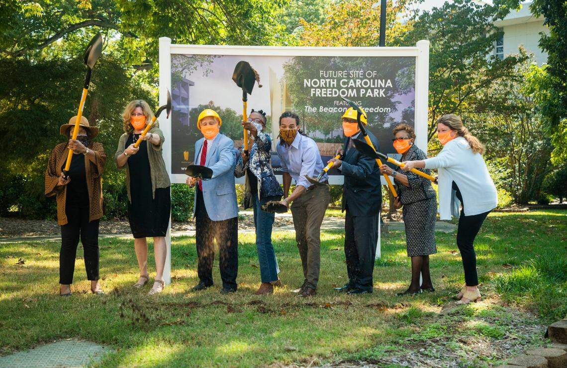 A group of park board members, state officials, and family of the late architect Phil Freelon, ceremoniously break ground on the new North Carolina Freedom Park, located between the NC State Legislative Building and the Executive Mansion, on Wednesday, Oct. 7, 2020, in Raleigh, N.C.