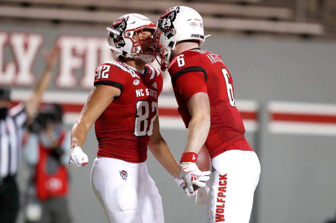 N.C. State tight end Cary Angeline (6) celebrates with Max Fisher (82) after Angeline scored on a 15-yard touchdown reception during the second half of N.C. State’s 45-42 victory over Wake Forest at Carter-Finley Stadium in Raleigh, N.C, Saturday, Sept. 19, 2020.