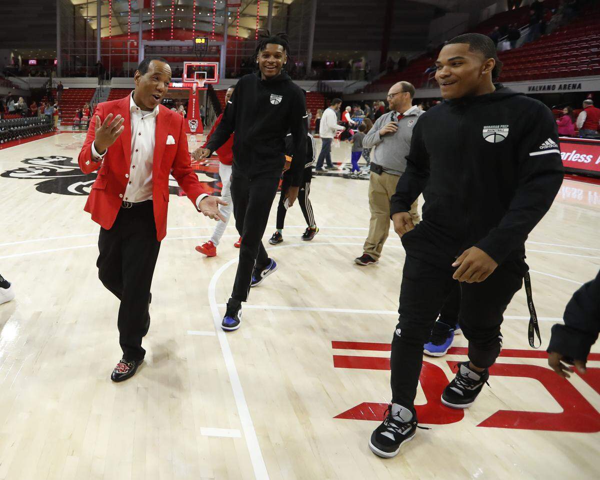 N.C. State head coach Kevin Keatts talks with signees Josh Hall, center, and Shakeel Moore after the Wolfpack’s victory over St. Francis Brooklyn at Reynolds Coliseum in Raleigh, N.C., Saturday, Nov. 16, 2019.