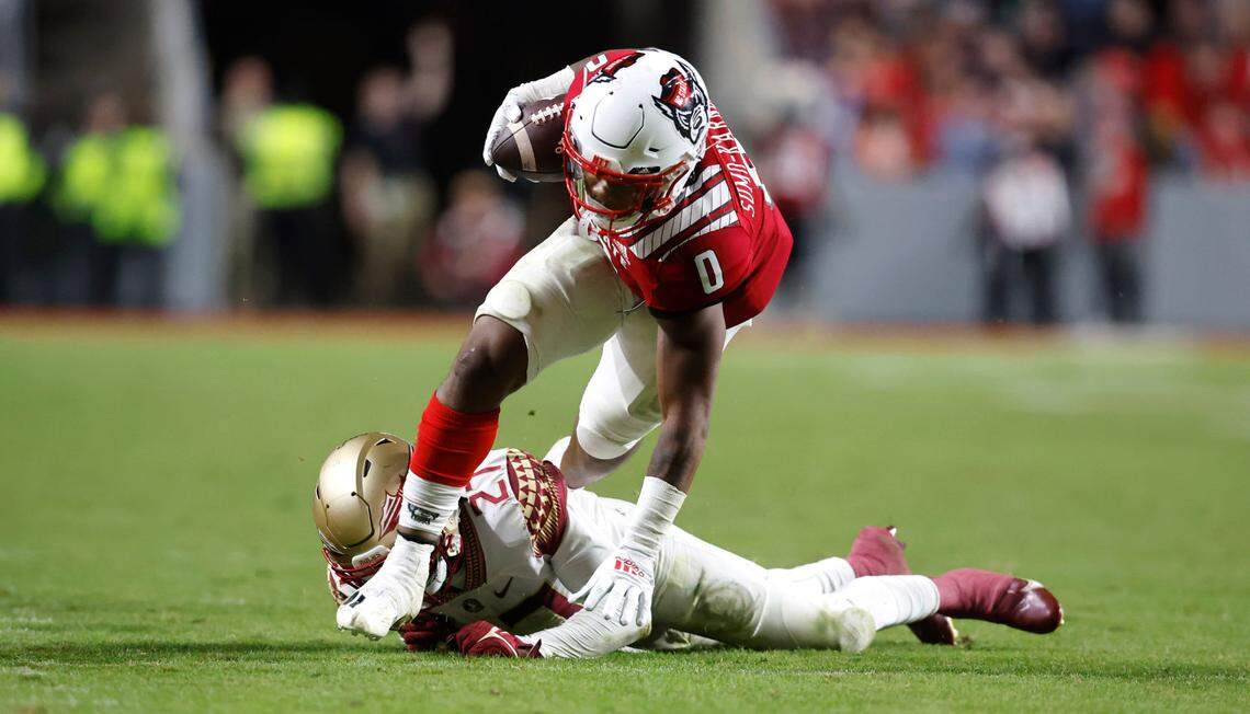 N.C. State running back Demie Sumo-Karngbaye (0) gets by Florida State defensive back Akeem Dent (27) during the second half of N.C. State’s game against Florida State at Carter-Finley Stadium in Raleigh, N.C., Saturday, Oct. 8, 2022.