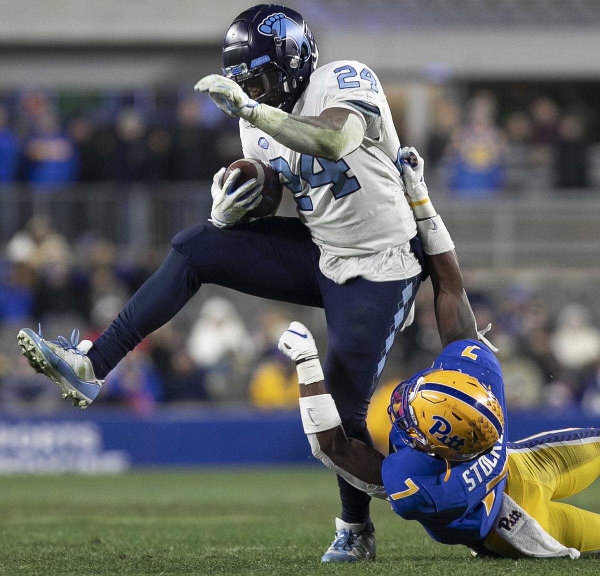 North Carolina’s Antonio Williams (24) breaks away from Pittsburgh’s Jazze Stocker (7) for a seven yard gain in the fourth quarter on Thursday, November 14, 2019 at Heinz Field in Pittsburgh, Pa.