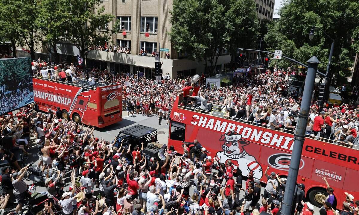 The Canes, including Carolina's Jaccob Slavin  and Sebastian Aho raise the Cup as the ride down Fayetteville St. during a parade and rally for the Carolina Hurricanes in downtown Raleigh Saturday, June 20, 2026.