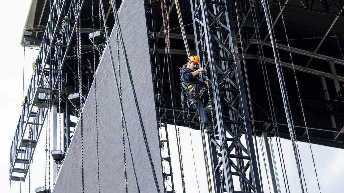 A rigger assembles the main stage for the Dreamville Festival at Dorothea Dix Park in Raleigh on Thursday, April 4, 2024. The hip-hop festival, running Saturday and Sunday, April 6 and 7, will feature more than two dozen acts, including 50 Cent, SZA, J. Cole, and Nicki Minaj.
