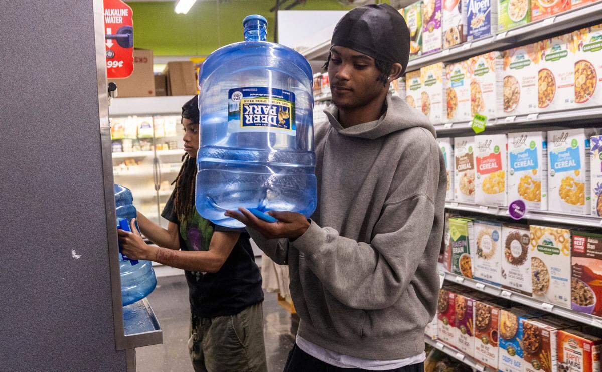 Jada Jinwright, left, Jamari Williams of Pittsboro fill water bottles at Chatham Marketplace in Pittsboro on Tuesday, May 7, 2024.