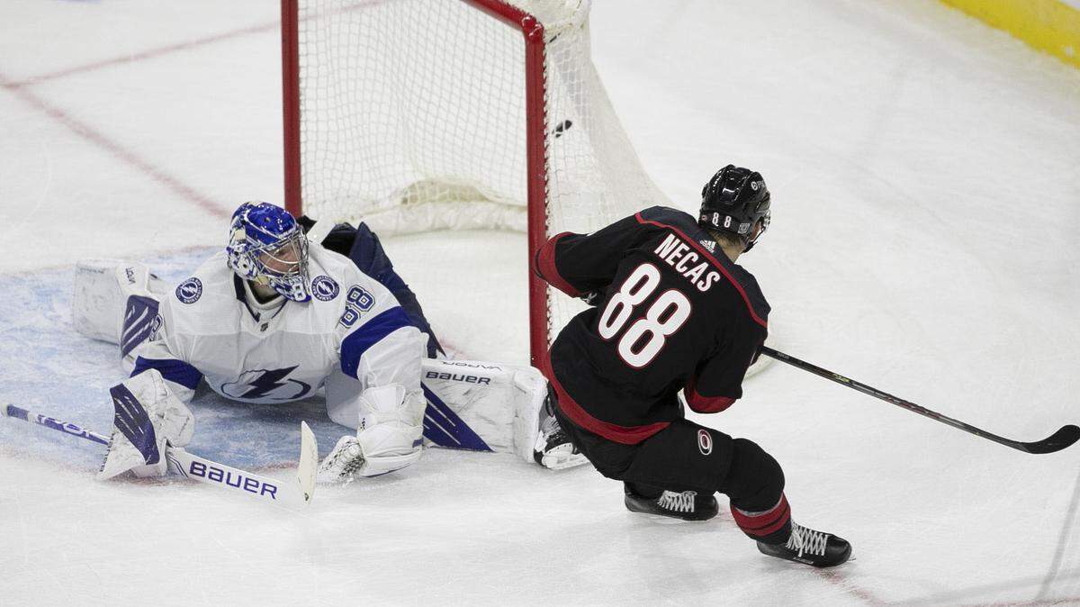 Carolina Hurricanes’ Martin Necas (88) scores on Tampa Bay goalie Andrei Vasilevskiy (88) to give the Hurricanes a 1-0 sudden death overtime victory in their season home opener on Thursday, January 28, 2021 at PNC Arena in Raleigh, N.C.