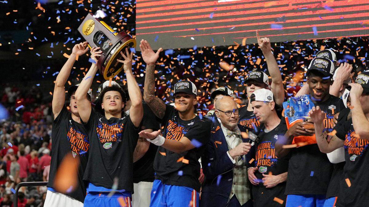 Florida Gators guard Walter Clayton Jr. (1) holds up the trophy after winning the national championship game of the Final Four of the 2025 NCAA Tournament at the Alamodome.