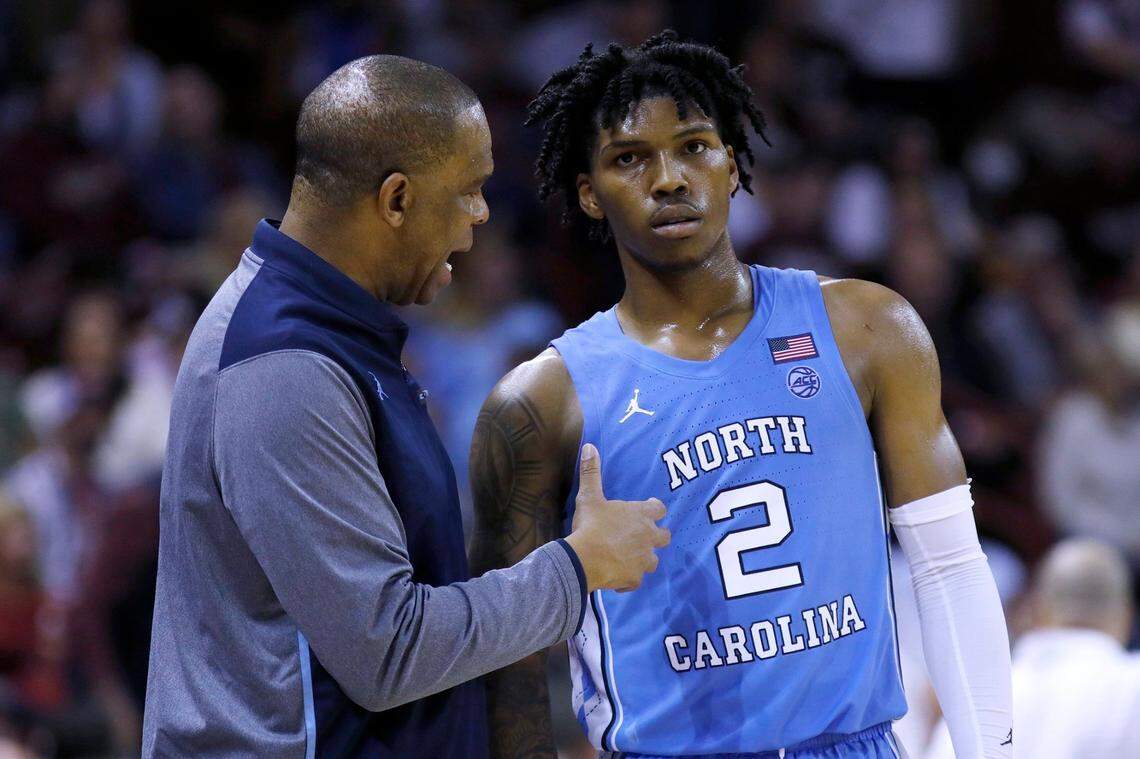 North Carolina coach Hubert Davis talks to Caleb Love (2) during the team’s NCAA basketball game against College of Charleston, during the second half Tuesday, Nov. 16, 2021, in Charleston, S.C. (AP Photo/Mic Smith)