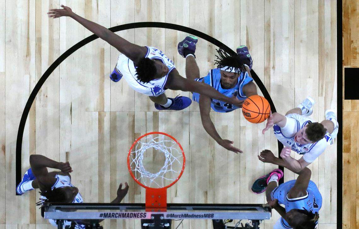 Duke’s Cooper Flagg (2) blocks the shot by Mount St. Mary’s Jedy Cordilia (14) during Duke’s 93-49 victory over Mount St. Mary’s in the first round of the 2025 NCAA Men’s Basketball Tournament at the Lenovo Center in Raleigh, N.C., Friday, March 21, 2025. Duke’s Patrick Ngongba II (21) also defends.