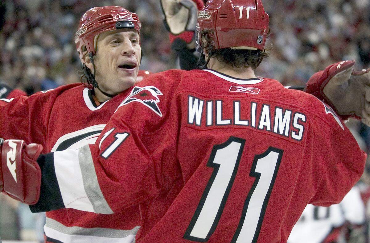 The Canes’ Rod Brind’Amour (17) congratulates teammate Justin Williams (11) after Williams scored during the third period of play on Monday May 22, 2006 at the RBC Center.