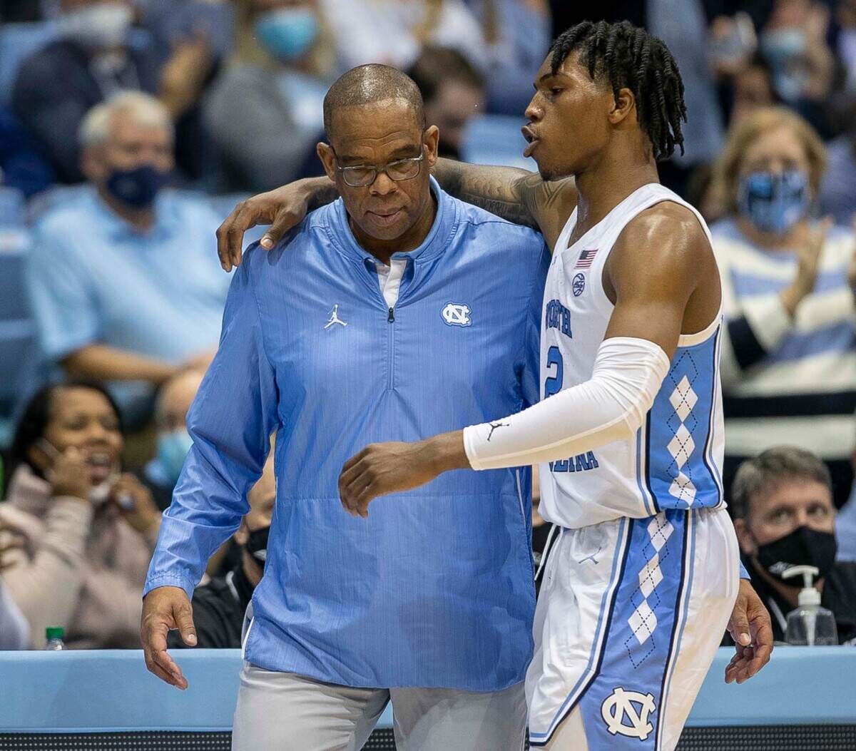 North Carolina’s Caleb Love (2) embraces head coach Hubert Davis as he comes of the game late in the second half against Loyola Maryland on Tuesday, November 9, 2021 in Chapel Hill, N.C. Love lead the Tar Heels’ with 22 points in their 83-67 victory.