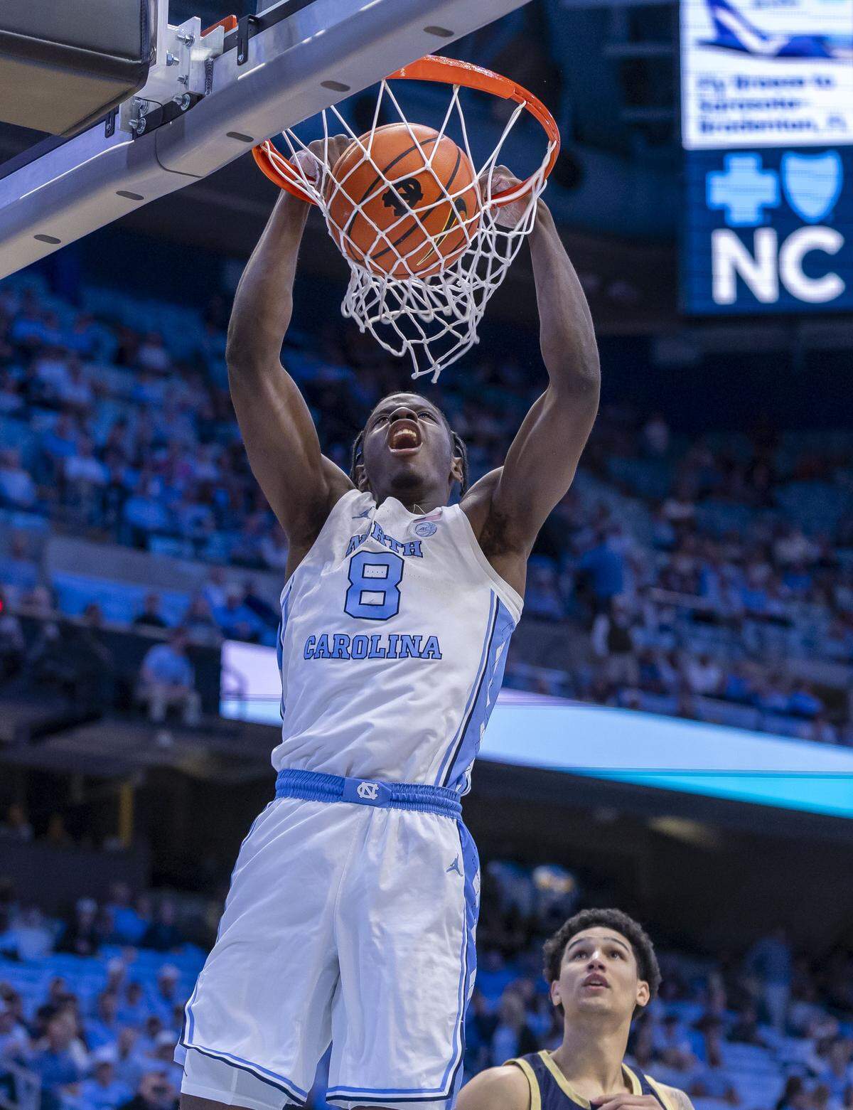 North Carolina forward Caleb Wilson (8) dunks over Navy forward Donovan Draper (11) in the first half on Tuesday, November 18, 2025 at the Smith Center in Chapel Hill, N.C