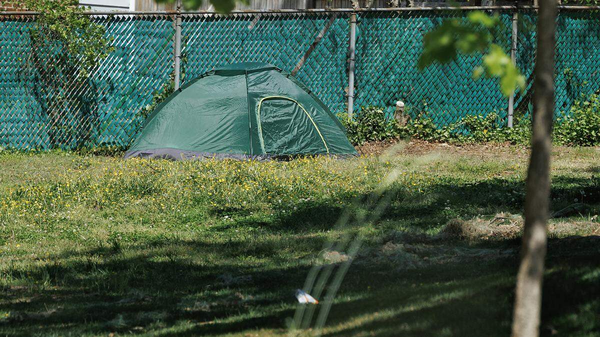A tent sits near a fence at Oakwood Park on Tuesday, April 14, 2026, in Durham, N.C.
