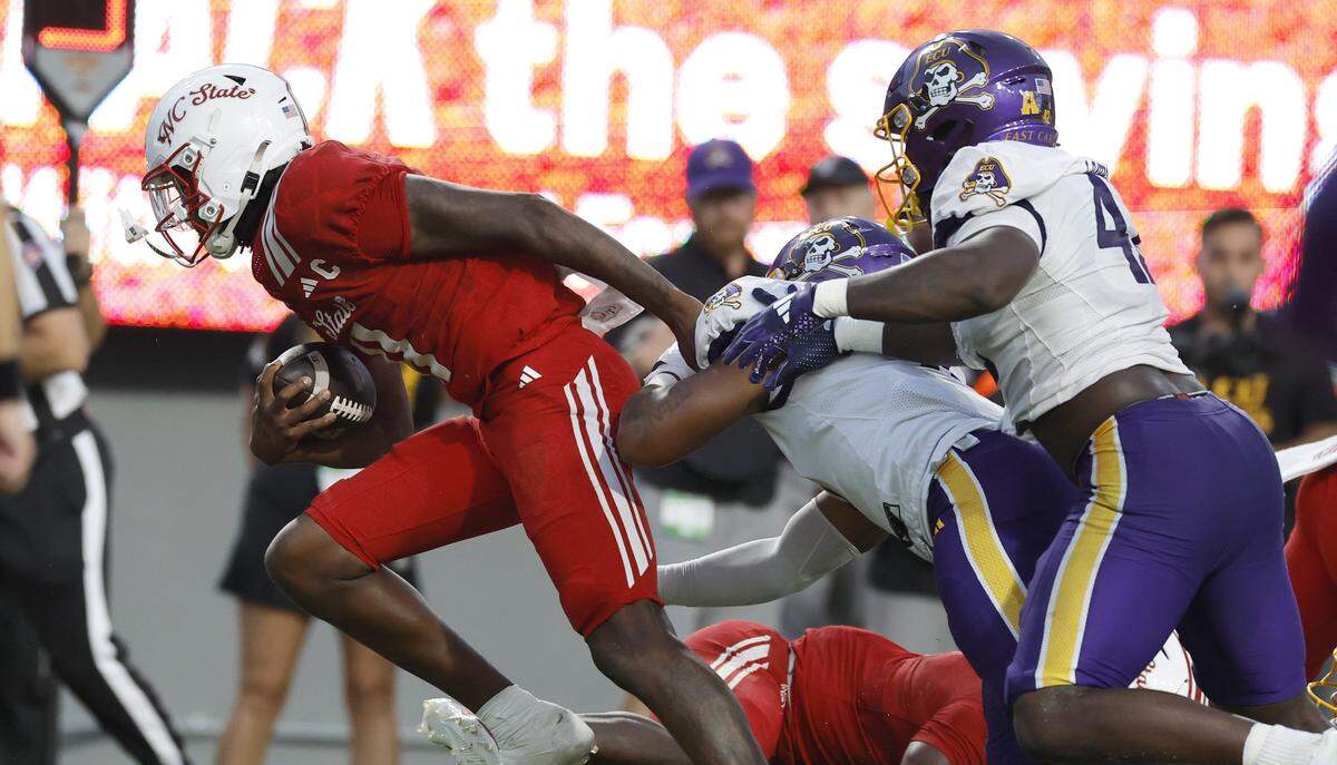 N.C. State quarterback CJ Bailey (11) breaks away from the East Carolina defense to score on a 11-yard touchdown run during the first half of N.C. State’s game against ECU at Carter-Finley Stadium in Raleigh, N.C., Thursday, Aug. 28, 2025.