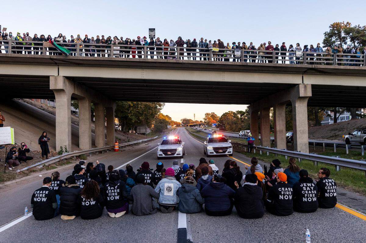 Protesters block the northbound lanes of the Durham Freeway at the South Magnum Street bridge for hours Thursday evening, Nov. 2, 2023 while demanding a ceasefire in the Israel-Gaza War as police warned of arrests.